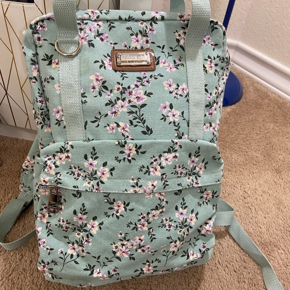New, never-used floral backpack. Light mint color.